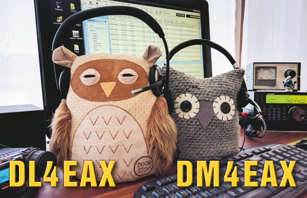 1) Kurzbeschreibung: QSL-Karte von DL4EAX und DM4EAX; zwei Eulen-Stofftiere mit Headsets vor einem Funkgerät mit Monitor und Tastatur; Rufzeichen in großen, gelben Schriftzeichen.
<ol start=